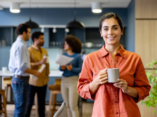 Businesswoman drinking coffee while taking a break at the office