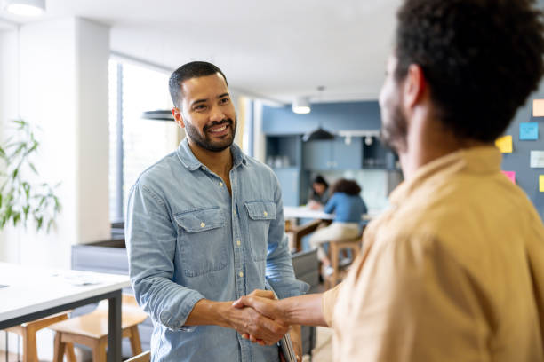 istock Business men greeting with a handshake at the office 2147591339