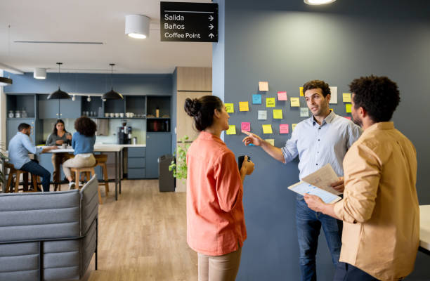 istock Business team brainstorming at the office and writing ideas on sticky notes 2147591346