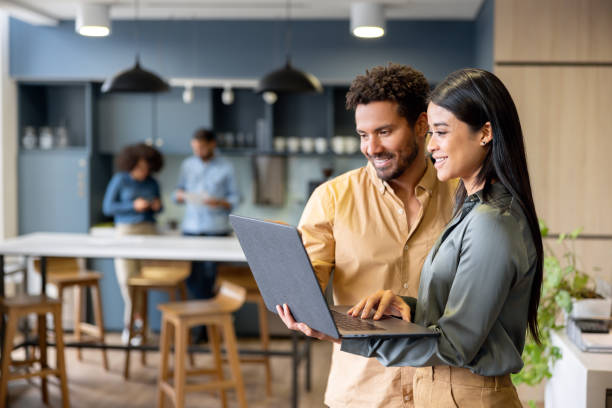 istock Business team working together using a laptop at the office and smiling 2147591350