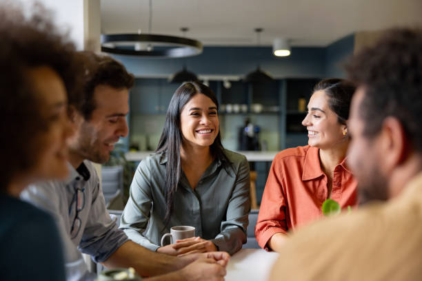 Happy businesswoman smiling in a meeting at the office Happy Latin American businesswoman smiling in a meeting at the office adult age stock pictures, royalty-free photos & images