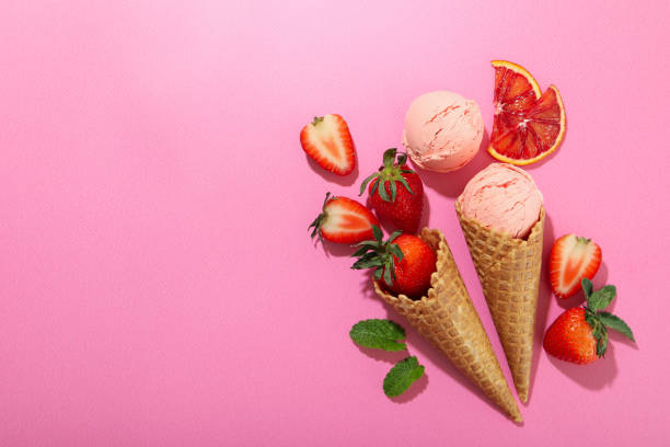 Strawberry - citrus ice cream on pink background, space for text