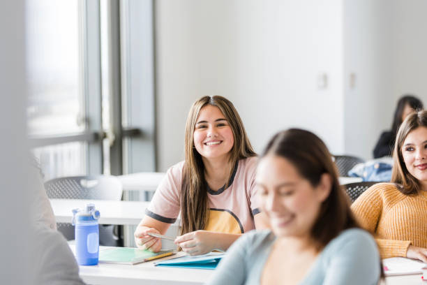 istock Young adult female students smile while attending class 2147592218