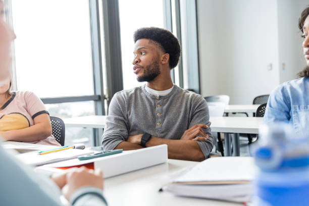 istock Young adult male looks at unseen peer while she asks a question 2147592224