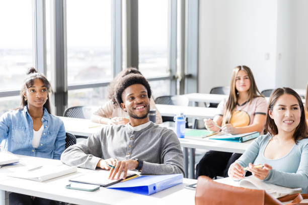 istock Multiracial group of high school students smile while their peer presents to the class 2147592233