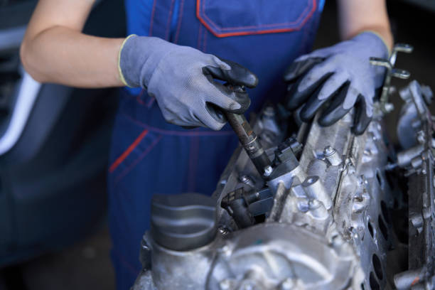 istock Woman auto mechanic at the workplace uses a special tool 2147593001
