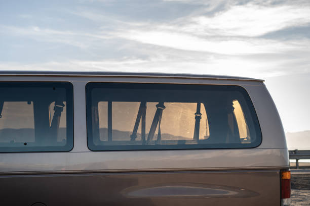 istock Beach Road Trip Backgrounds Lake Sunny Large Van Car 2147593701