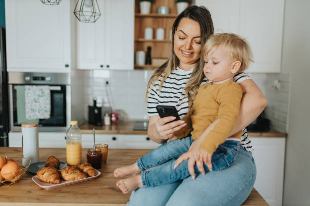 istock Mother and son taking selfie during breakfast at home 2147594217