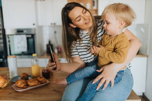 istock Mother and son taking selfie during breakfast at home 2147594566