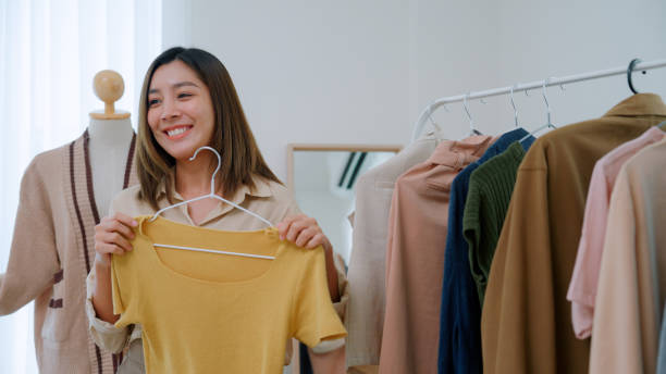 istock Asian woman live streaming for selling clothes 2147594603