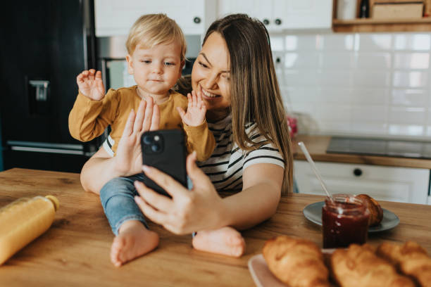 istock Mother and son having video call during breakfast 2147594631
