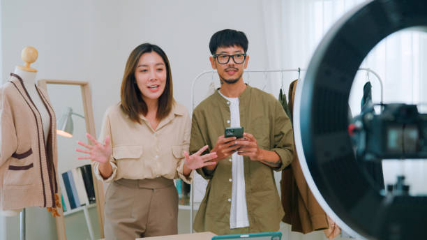 istock Asian couple live streaming for selling clothes 2147594642