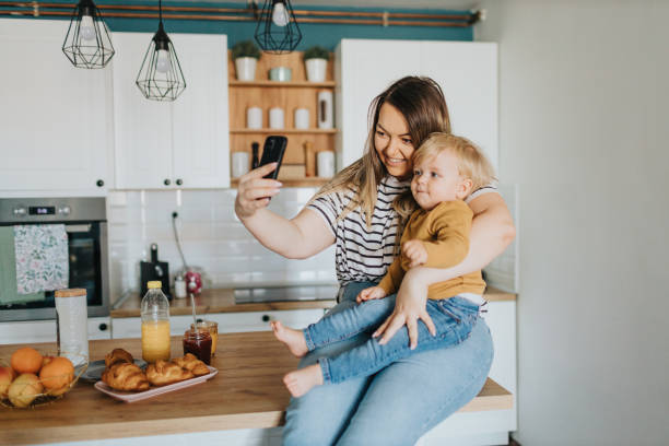 istock Mother and son taking selfie during breakfast at home 2147594683