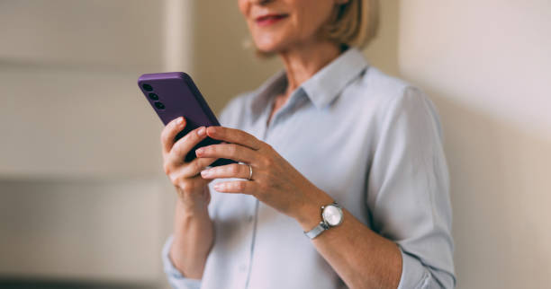 istock Senior Woman Using Smartphone in a Bright Room 2147595454