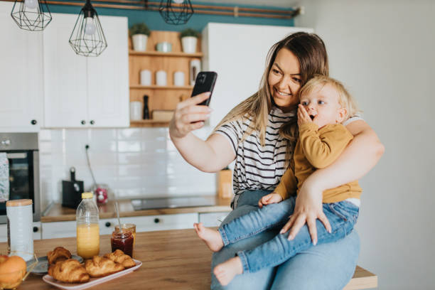 istock Mother and son taking selfie during breakfast at home 2147595617