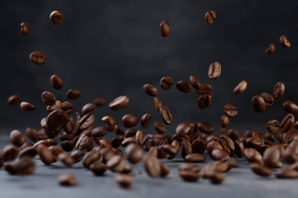 istock Many roasted coffee beans flying in the air. 2147596230