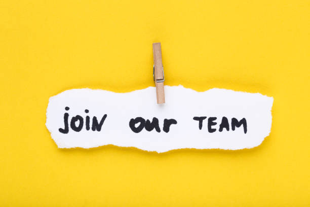 istock Text Join Our Team on white torn paper with clothespin 2147596288