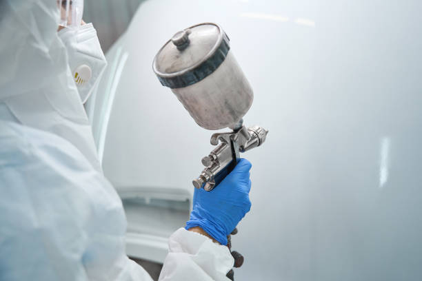 istock Person uses a paint injection tank at work 2147596424