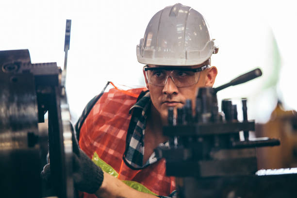 istock Male engineer metalworker industrial experienced operator technician worker in safety hard helmet working on lathe machine, professional man in industry technology manufacturing factory workshop 2147597031