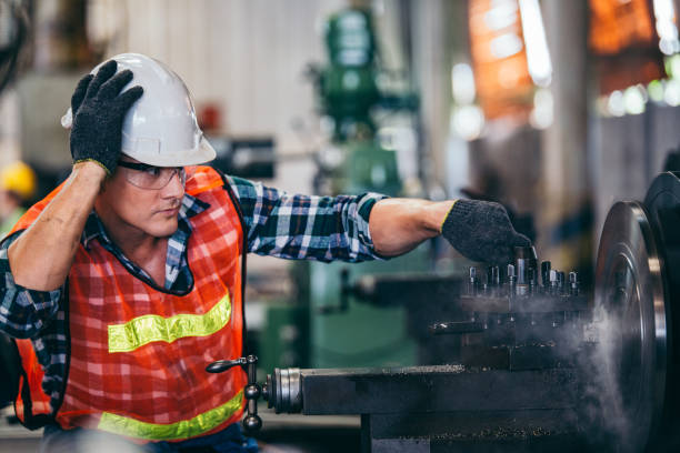 istock Male engineer metalworker industrial experienced operator technician worker in safety hard helmet working on lathe machine, professional man in industry technology manufacturing factory workshop 2147597279