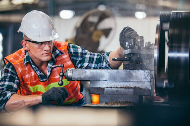 istock Male engineer metalworker industrial experienced operator technician worker in safety hard helmet working on lathe machine, professional man in industry technology manufacturing factory workshop 2147597397