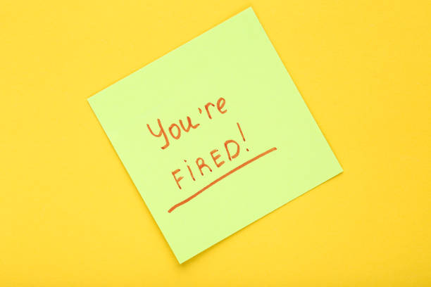istock Text You Are Fired on paper on yellow background 2147597875