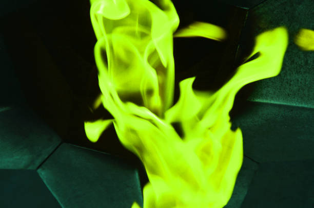 Green neon smoke on a dark background. Abstract flame texture.