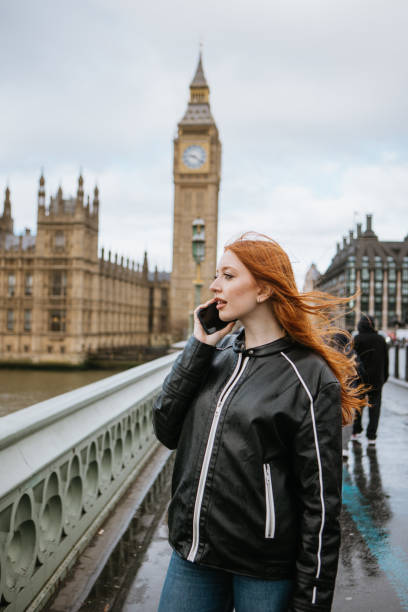 istock Woman using phone on Westminster Bridge 2147599168