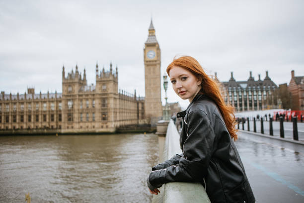 istock Happy woman standing on Westminster Bridge 2147599878