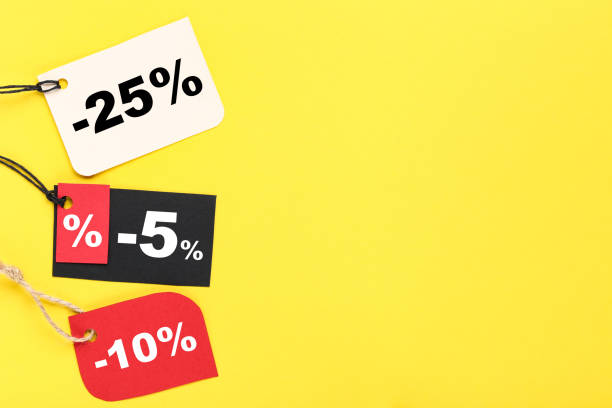 istock Colorful sale tags with percents on yellow background 2147600500