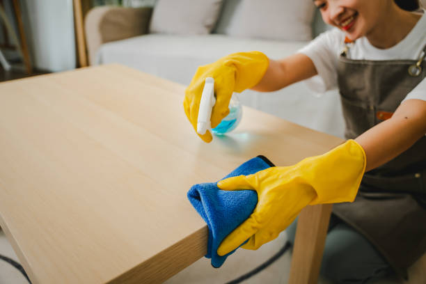 istock Young female housekeeper cleaning And wipe down the table with a microfiber cloth in the living room. young woman doing housework Housekeeping concept 2147601337