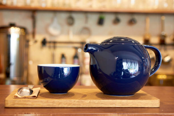 istock Blue ceramic teapot and cup on a coffee shop counter 2147602279