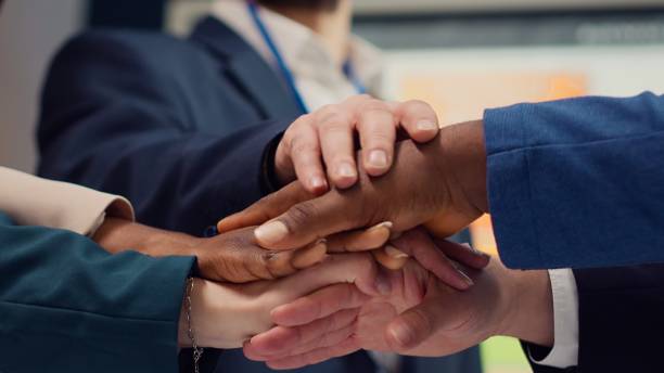 istock Business affiliates connecting hands and raising them up in celebration 2147603225