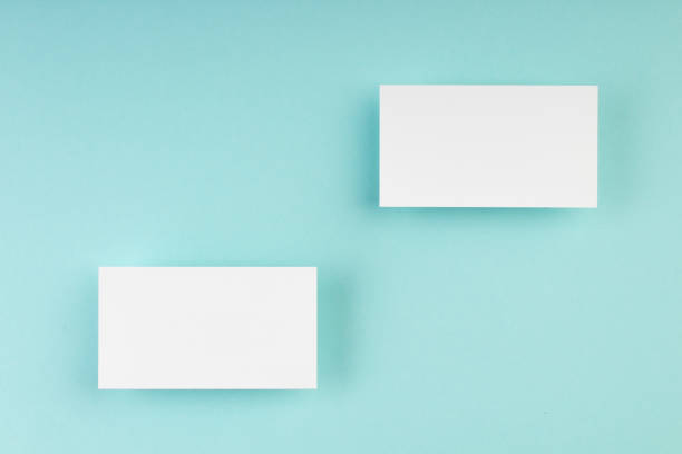 istock Business card blank over colorful background. Copy space for text. Top view.Business card blank over colorful abstract background. Corporate stationery branding mock-up. Copy space for text. Top view. 2147606607