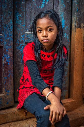 Portrait of young Nepali girl, she lives in Bhaktapur. Bhaktapur is an ancient town in the Kathmandu Valley and is listed as a World Heritage Site by UNESCO for its rich culture, temples, and wood, metal and stone artwork.