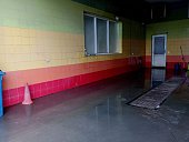 Car wash premises, the walls of which are lined with multi-colored ceramic tiles. the topic of car washing in a specially designated place.