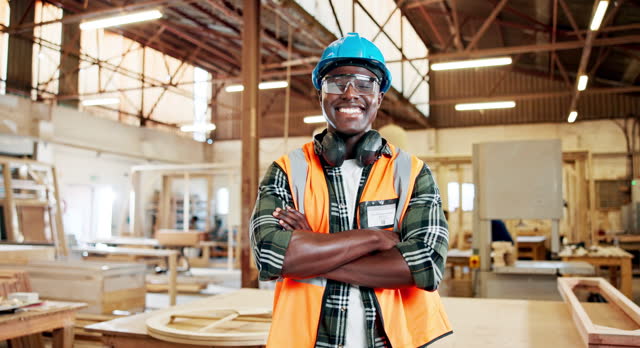 Black man, carpenter with face and arms crossed in workshop for wood work, trade and confident in workplace. Pride, portrait and carpentry, professional service and artisan with handyman at factory