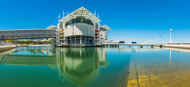 Clear blue skies over the futuristic developments of the Parque das Nacoes and Oceanario de Lisboa on the Tagus waterfront in the heart of Lisbon, Portugal’s vibrant capital city.