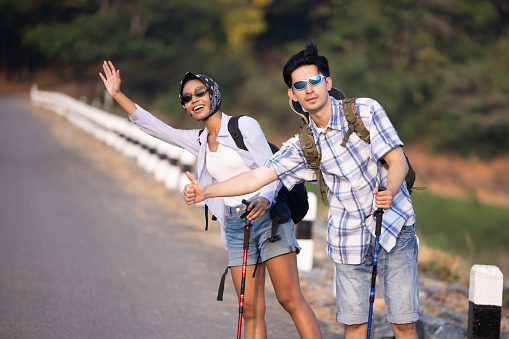 Travellers hitchhiking for the ride  during mountain trip
