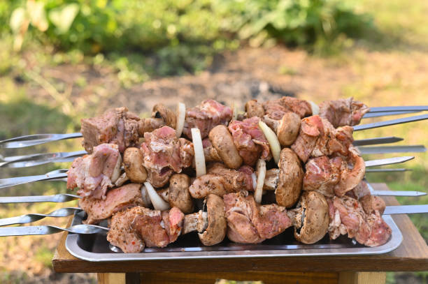 istock raw meat on barbecue skewers. 2147610447