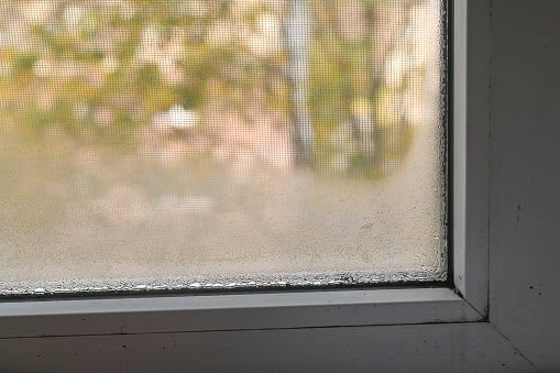 The fogged window. wet glass due to dampness