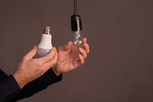 incandescent lamp and LED lamp in hand