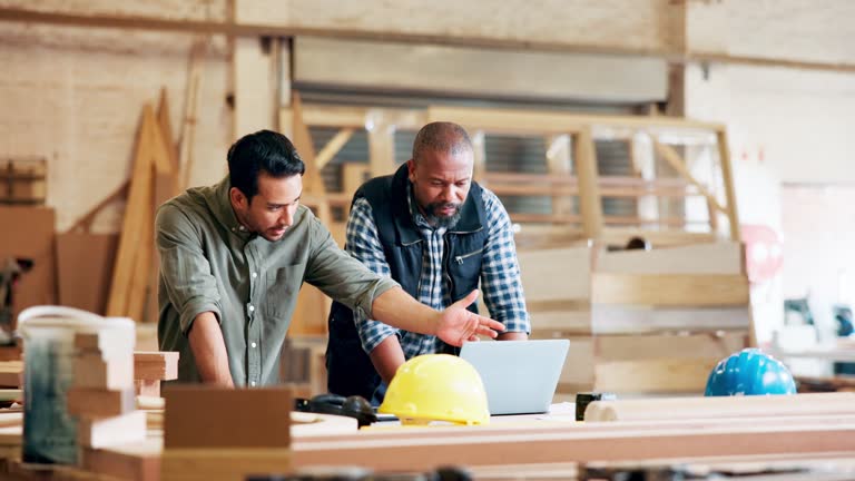 Teamwork, coworker and architect with laptop in desk or typing, collaboration and discuss design. Workplace, colleagues and men as engineer with meeting in startup business for construction project