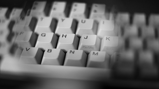 Black and White Freelensed Macro image of a Computer Keyboard, focussed on the letter H, with a soft edged surround