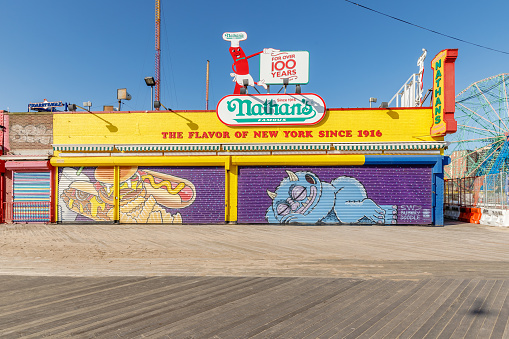 Brooklyn, New York City, USA - February 18, 2023: Facade of the waterfront Nathan's fast food stand restaurant at Coney Island closed on a winter day