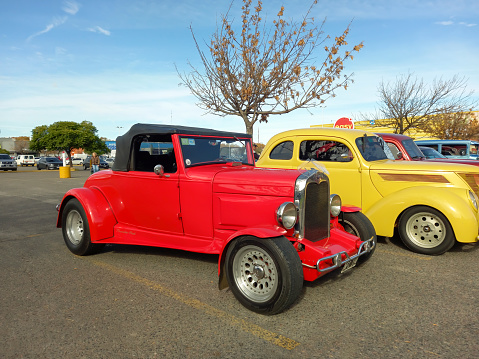 Buenos Aires, Argentina - Jun 4, 2023: Old red Ford model A roadster hot rod circa 1930 in a parking lot. Classic car show. Sunny day. Copyspace