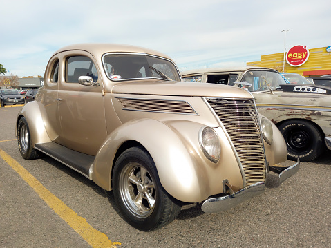 Buenos Aires, Argentina - Jun 4, 2023: Old grey 1937 Ford V8 coupe 5 window street rod in a parking lot at a classic car show.