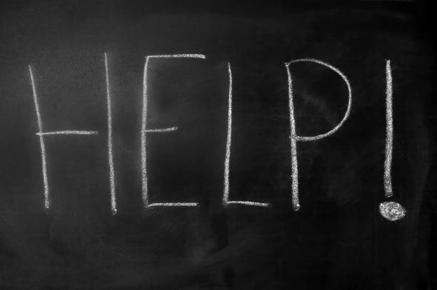Word help with an exclamation written with white chalk on a black blackboard
