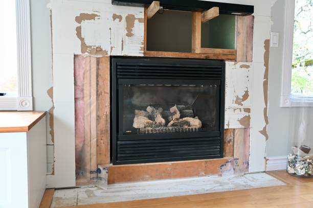 Home renovation projects, simple weekend construction to update and modernize the living room Home renovation projects replacing tile surround on gas fireplace in family room to revitalize the room drywall fireplace stock pictures, royalty-free photos & images