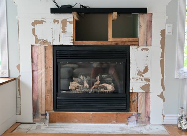 Home renovation projects, simple weekend construction to update and modernize the living room Home renovation projects replacing tile surround on gas fireplace in family room to revitalize the room drywall fireplace stock pictures, royalty-free photos & images